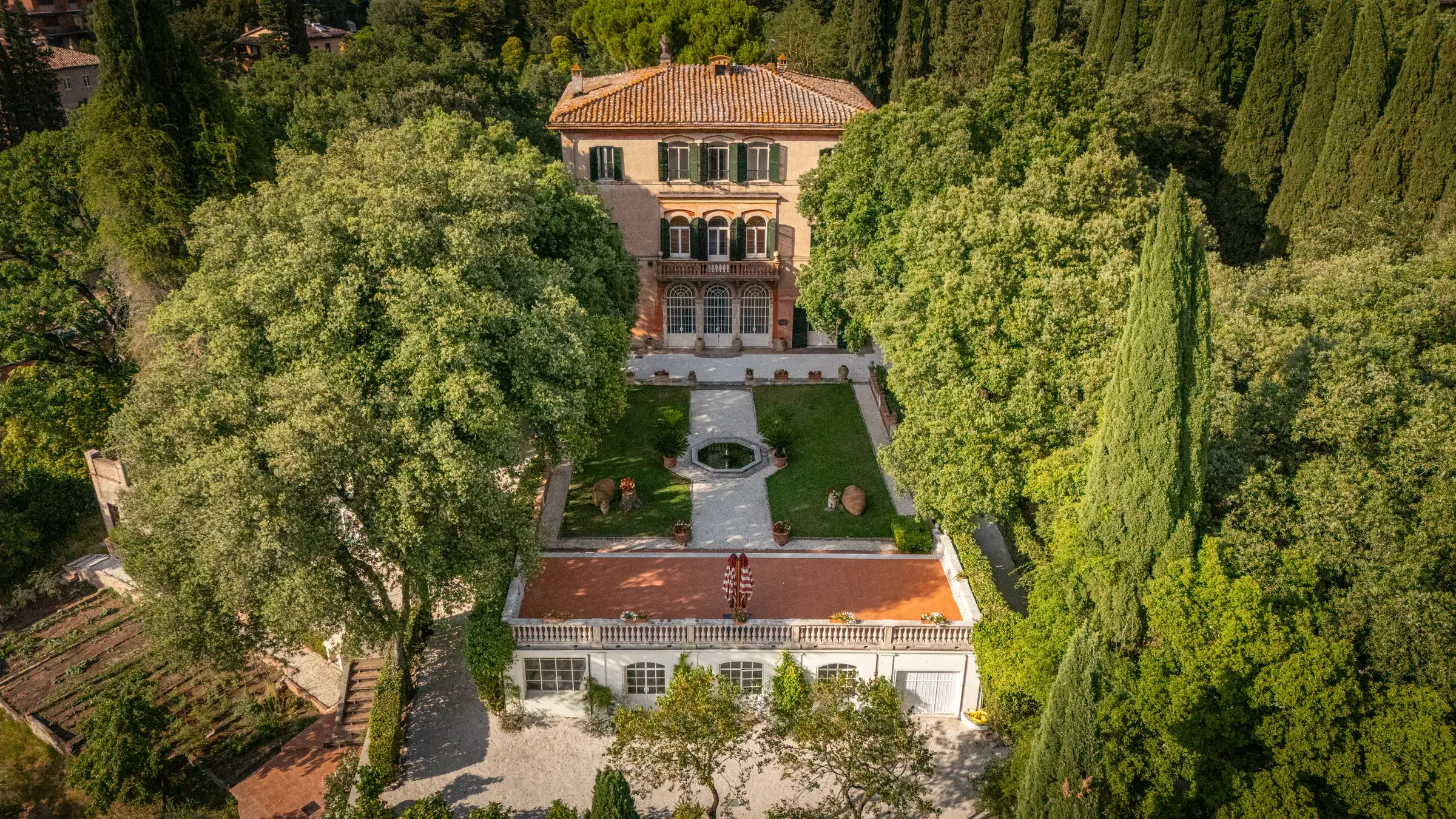 Aerial view of Villa Milleri Santos and its formal garden among cypresses